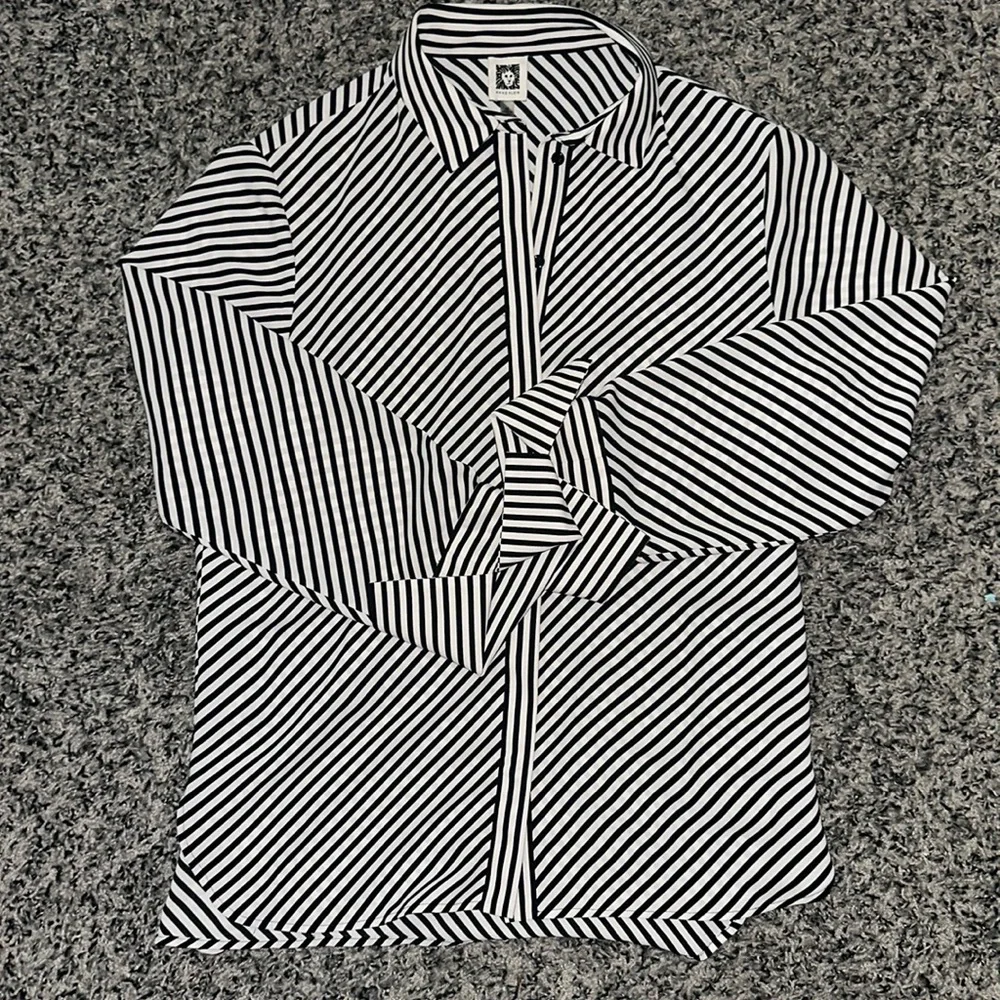 Woman’s Anne Klein stripped button down top. Size M.